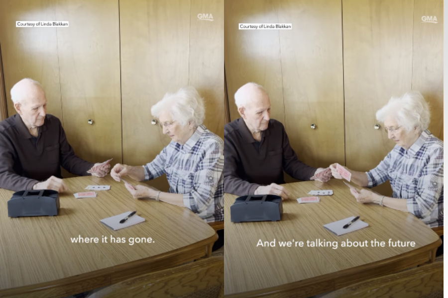 Two side-by-side images show an elderly couple sitting at a wooden table, engaged in a card game. The man wears a dark sweater and the woman wears a plaid shirt; they smile and concentrate on their cards. A black case, notepad, and pen sit on the table. Subtitles read: “where it has gone.” and “And we’re talking about the future.”