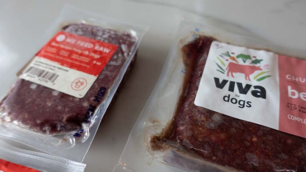 Frozen raw pet food products displayed on a kitchen counter