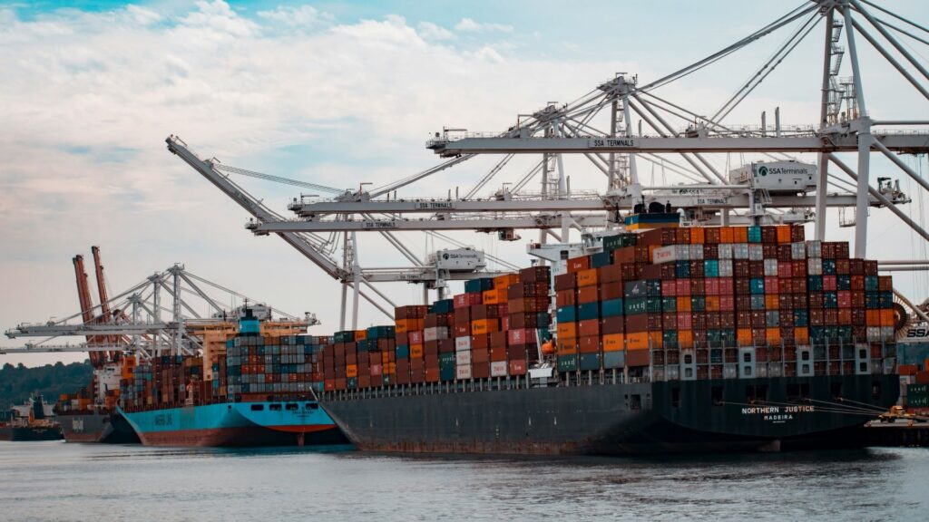 Cargo ships docked at a pier during daytime