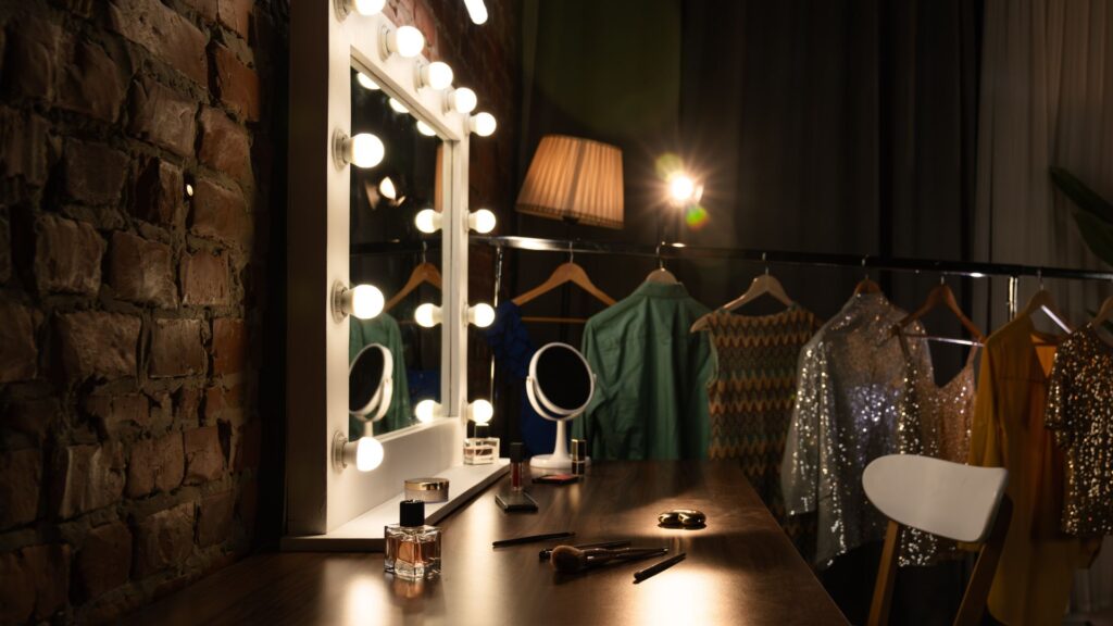 Dressing room mirror with bright round bulbs lit around the frame