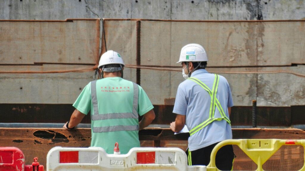 Construction workers wearing safety helmets at a job site