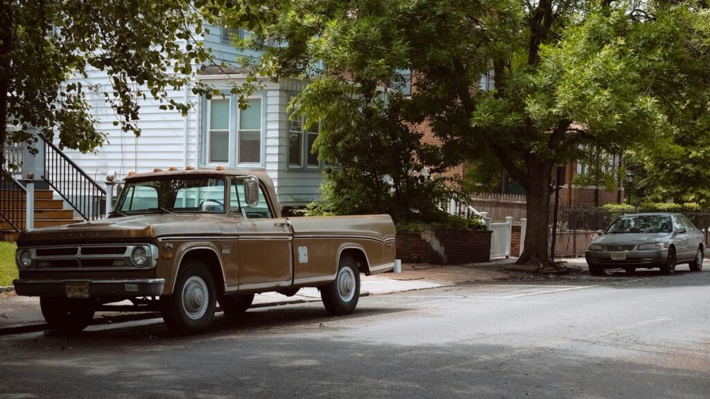 Brown delivery truck parked along a roadside