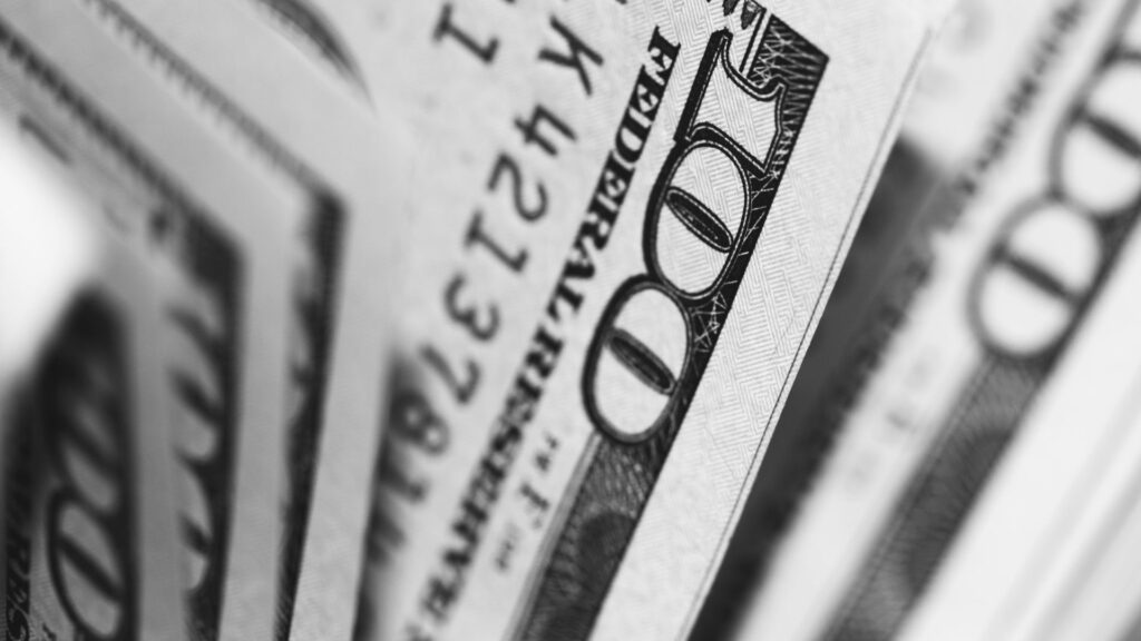 Close up view of 100 dollar bills stacked together